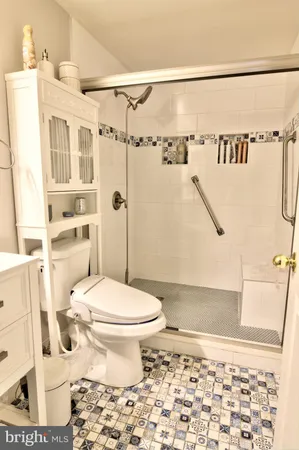 a bathroom with a toilet and a shower