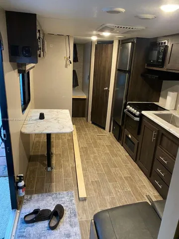 a kitchen with a refrigerator and a stove