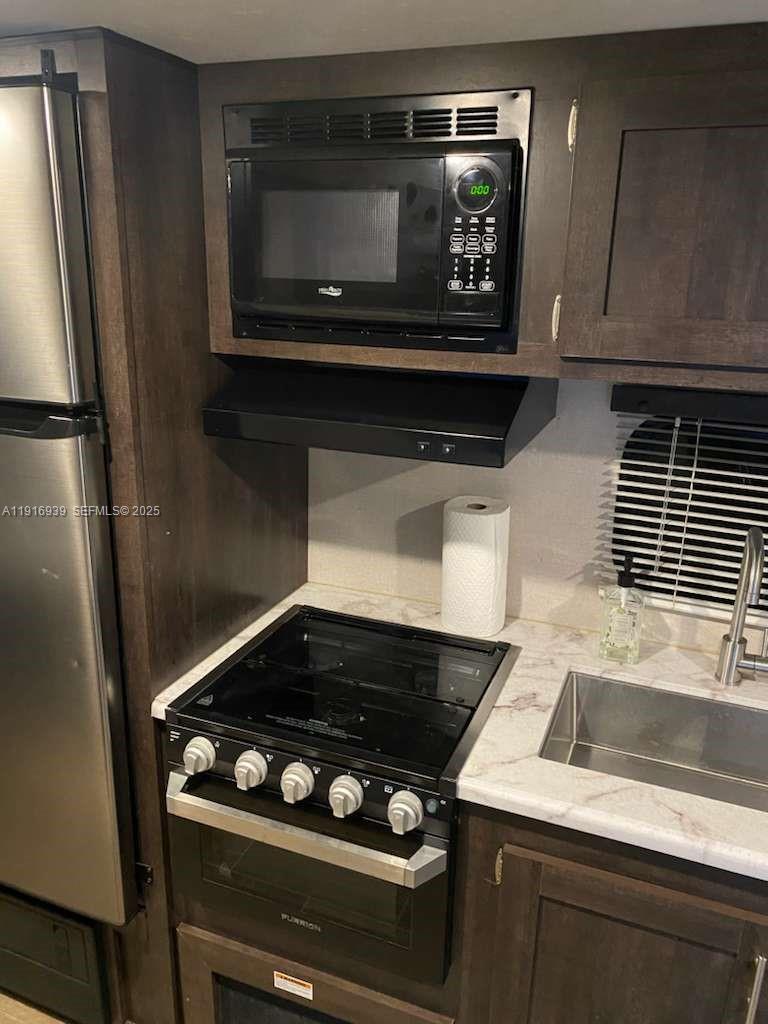 25236 Southwest 133rd Avenue Homestead, FL 33032 - Photo 4 of 18 a stove top oven sitting inside of a kitchen