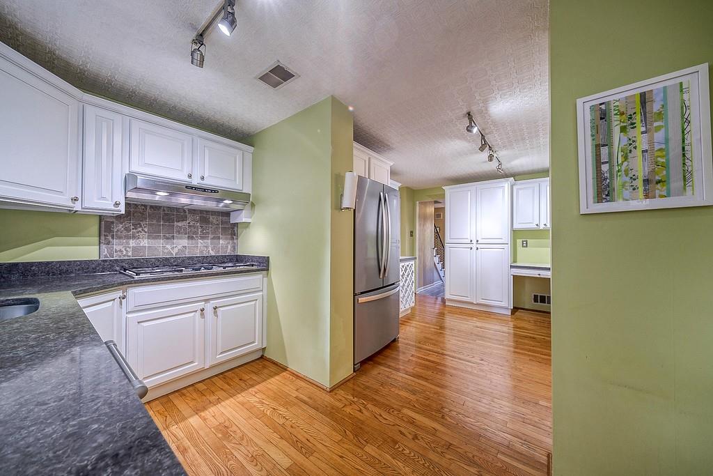 9120 Collington Square Allison Park, PA 15101 - Photo 19 of 38 a kitchen with granite countertop a refrigerator and a stove top oven