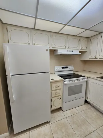a kitchen with appliances cabinets and a counter top space