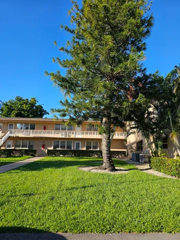 a view of a big house with a big yard
