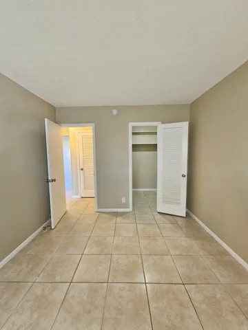 a view of an empty room and closet area