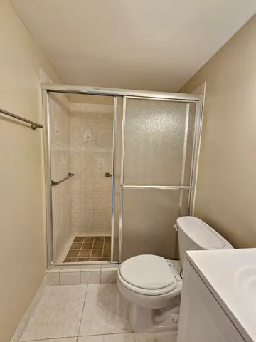 a bathroom with a toilet and a shower