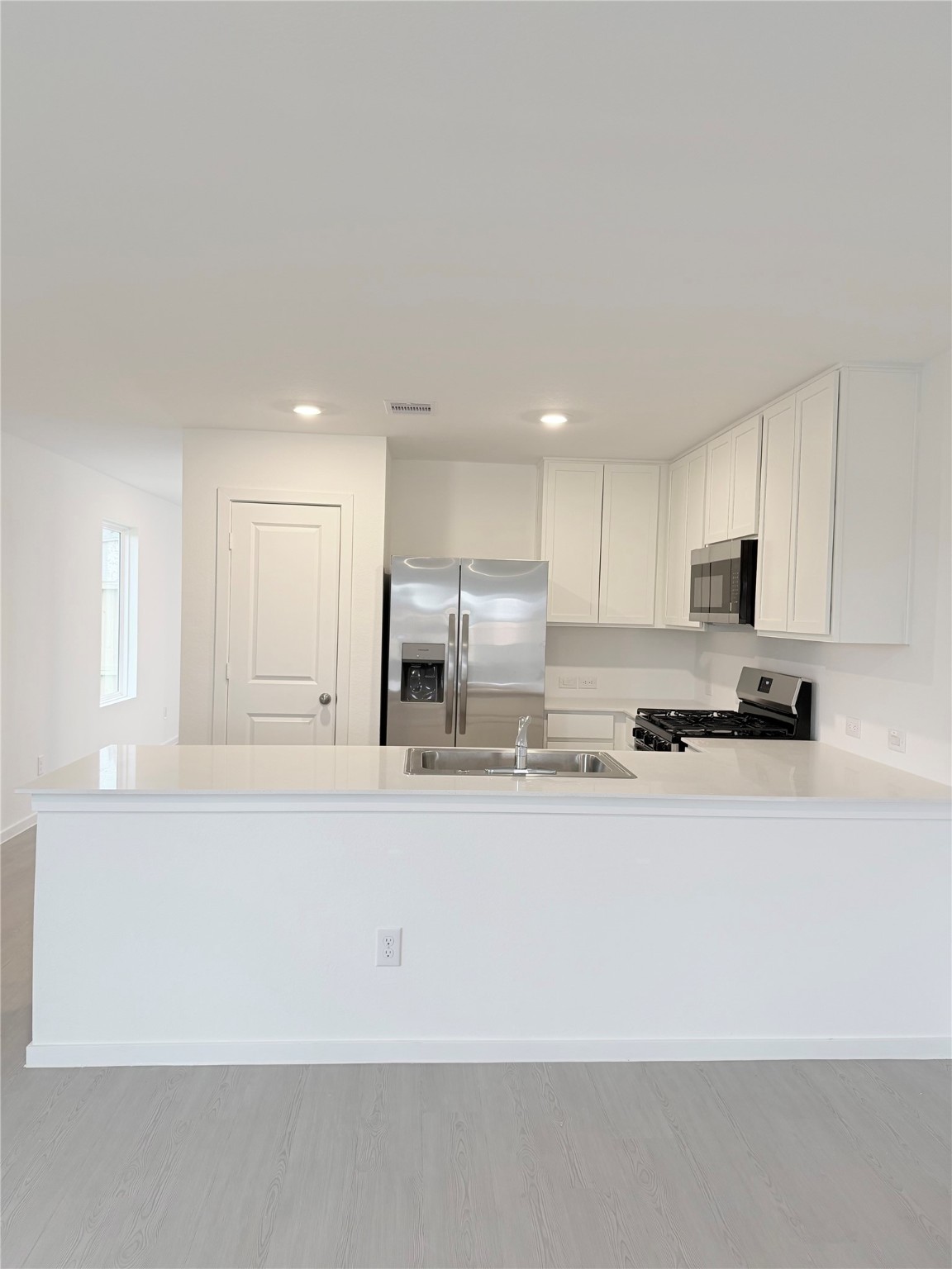 447 Southern Magnolia Way Magnolia, TX 77354 - Photo 1 of 21 a large white kitchen with kitchen island sink and a stove