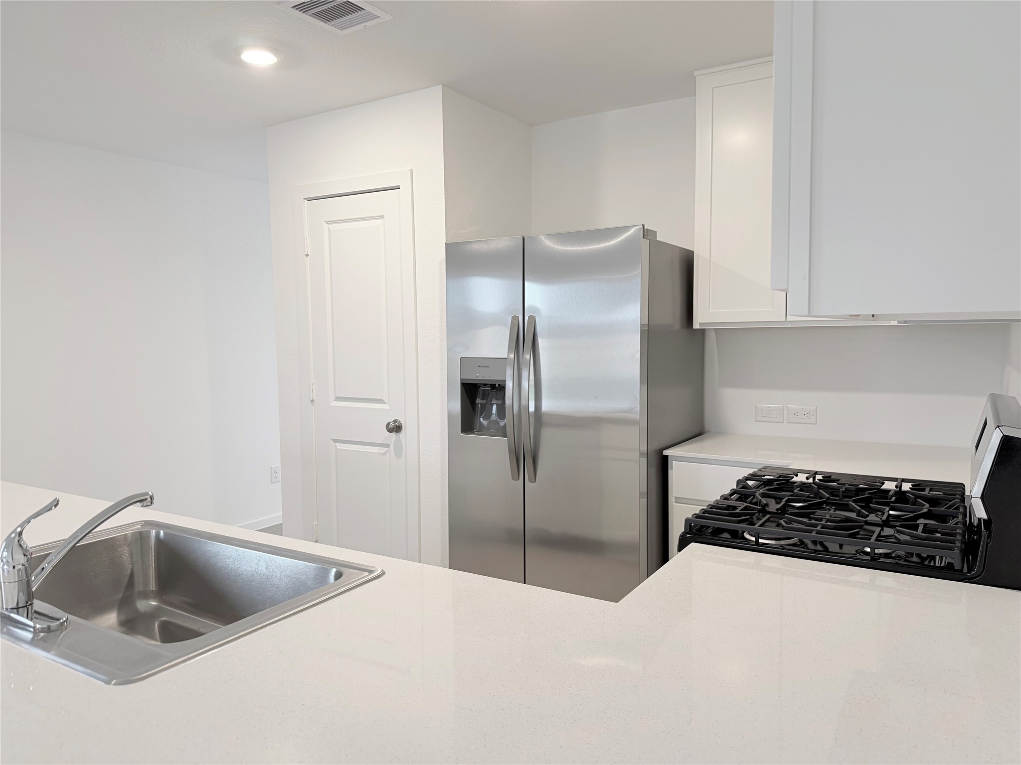 447 Southern Magnolia Way Magnolia, TX 77354 - Photo 12 of 21 a kitchen with a refrigerator and a sink
