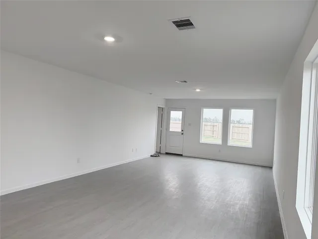 an empty room with windows and closet