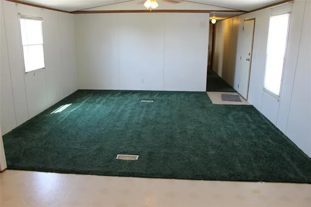 a kitchen with a sink a refrigerator and cabinets
