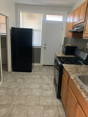 a kitchen with a stove and a refrigerator