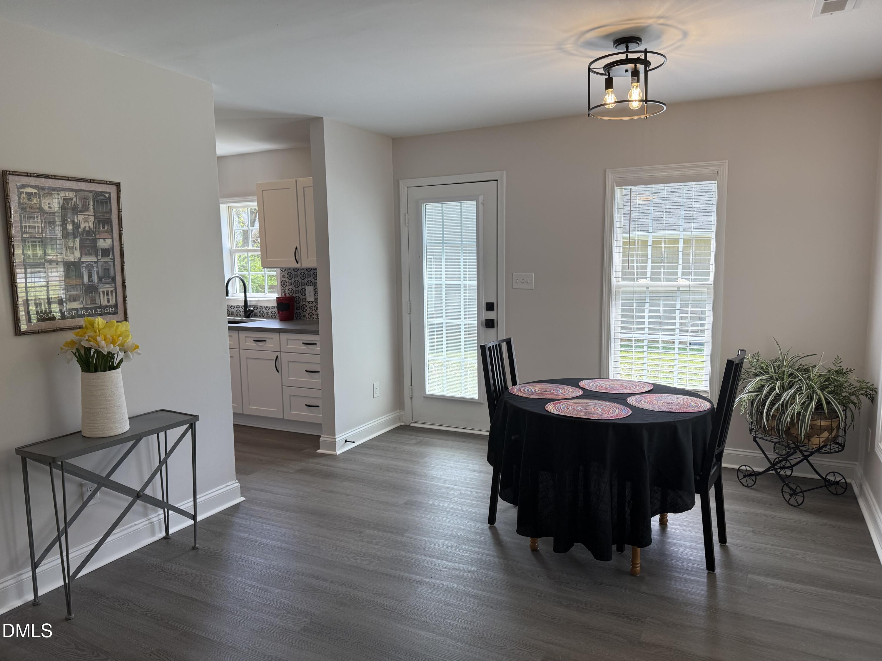 415 Sowell Street Durham, NC 27701 - Photo 3 of 17 a view of a dining room with furniture and wooden floor