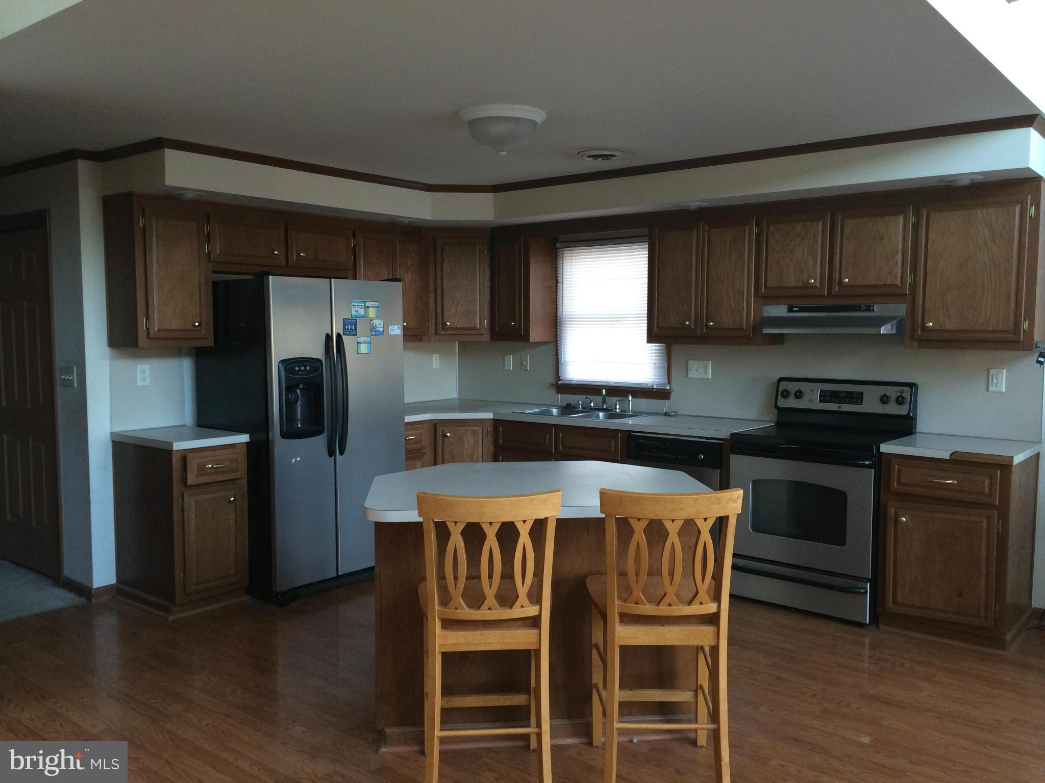 324 St Georges Road Baltimore, MD 21221 - Photo 4 of 15 a kitchen with stainless steel appliances a stove a sink refrigerator and a microwave