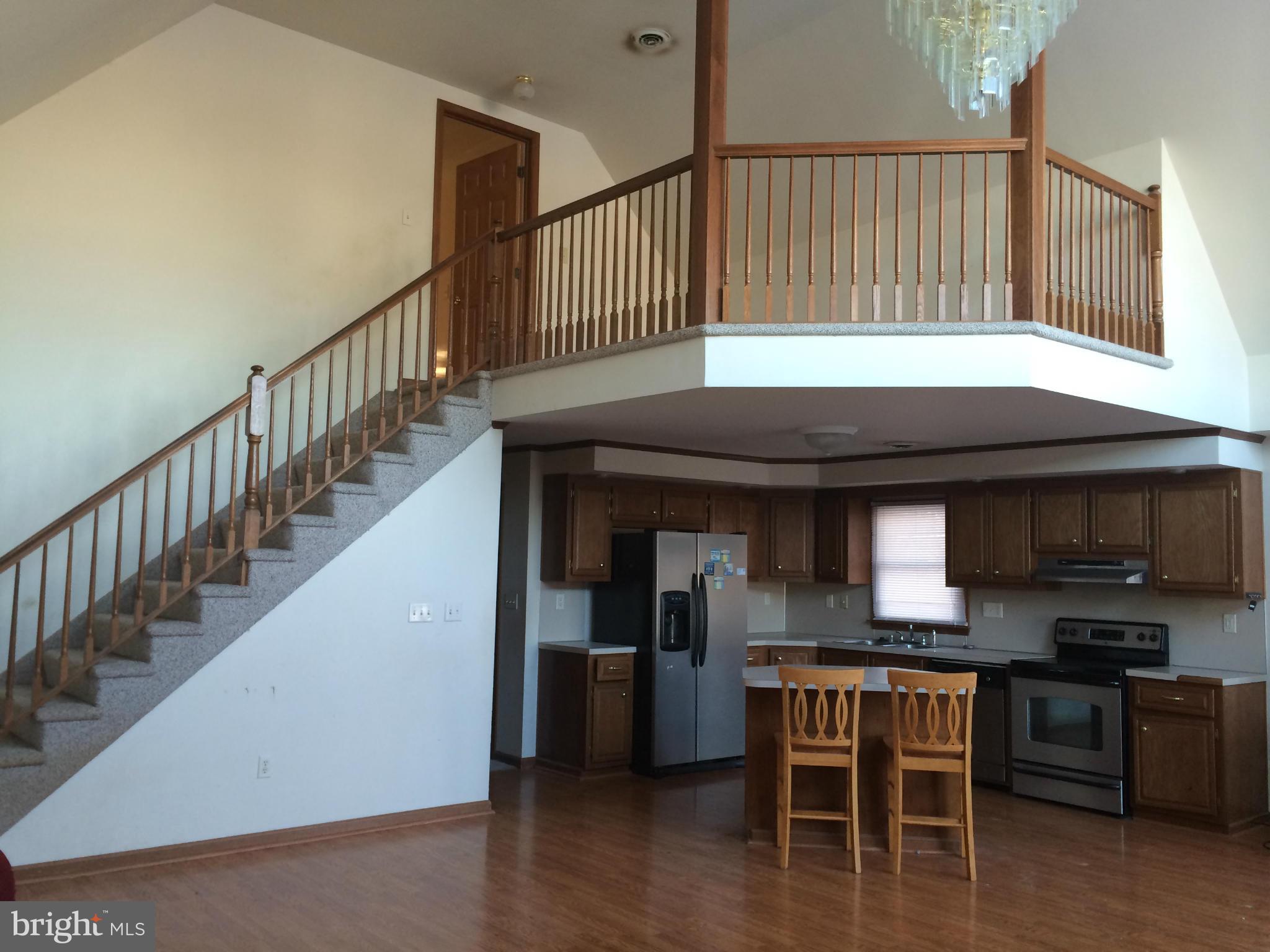 324 St Georges Road Baltimore, MD 21221 - Photo 6 of 15 a view of dinning room and kitchen with wooden floor and electronic appliances
