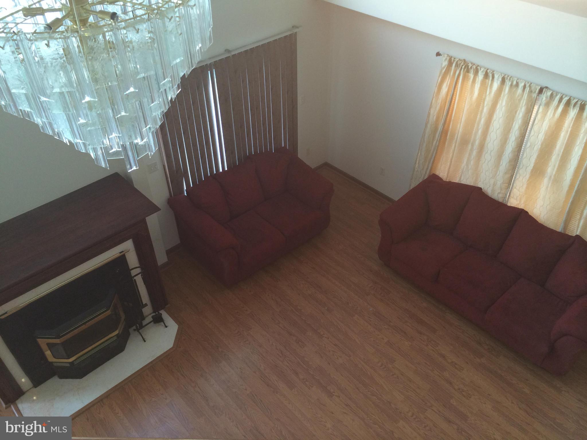 324 St Georges Road Baltimore, MD 21221 - Photo 9 of 15 a living room with furniture and a fireplace