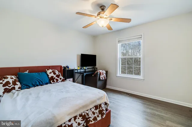 a backyard of a house with lots of trees and wooden fence