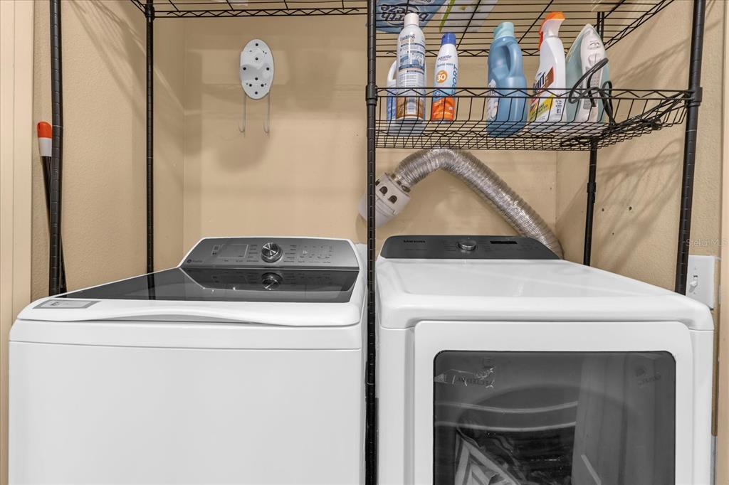 1362 Centre Ct Ridge Drive, Unit 102 Reunion, FL 34747 - Photo 23 of 35 a utility room with dryer and washer