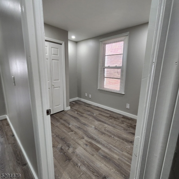 333 Clinton Street Haledon, NJ 07508 - Photo 11 of 13 a view of hallway with window and wooden floor