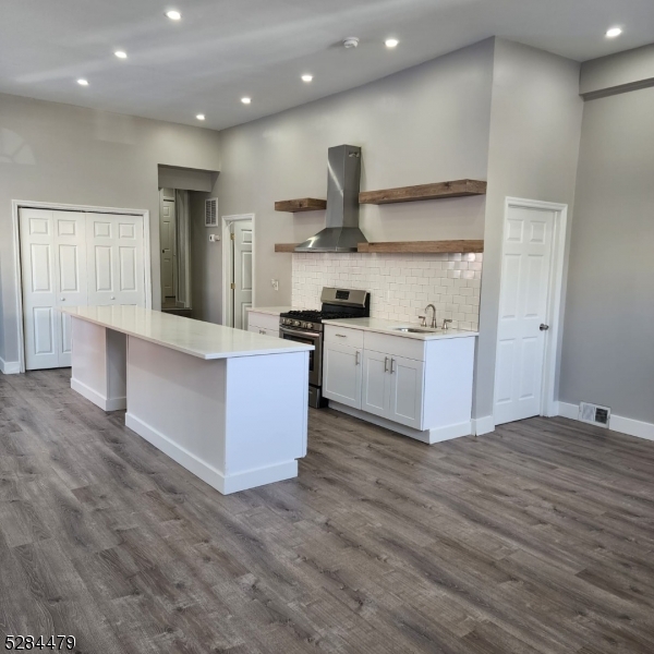 333 Clinton Street Haledon, NJ 07508 - Photo 2 of 13 a large kitchen with stainless steel appliances granite countertop a large counter top and a stove top oven