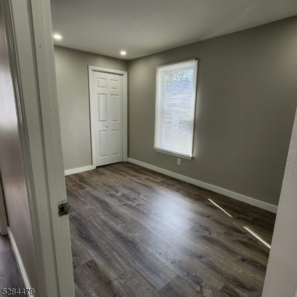 333 Clinton Street Haledon, NJ 07508 - Photo 7 of 13 an empty room with wooden floor and windows