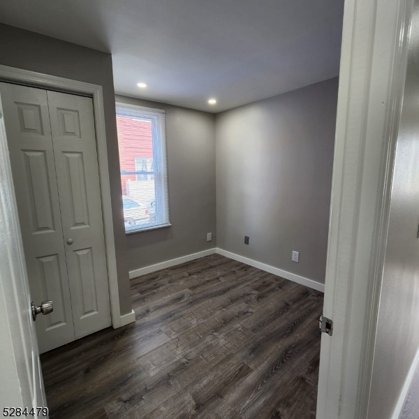 333 Clinton Street Haledon, NJ 07508 - Photo 8 of 13 an empty room with wooden floor and windows