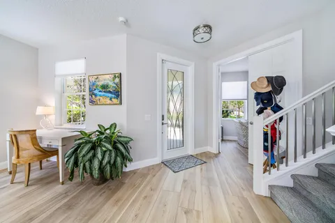 a living room with furniture and a potted plant