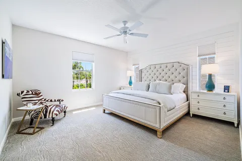 a bed room with a bed and a chair