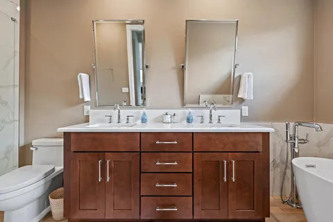 a bathroom with a sink vanity mirror and toilet