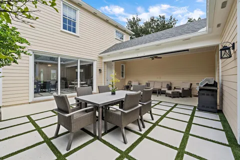 a view of a patio with table and chairs and potted plants