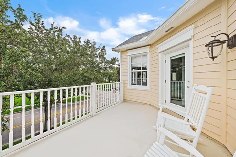 a view of a chair and table in the balcony