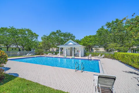 a view of a house with pool and a yard