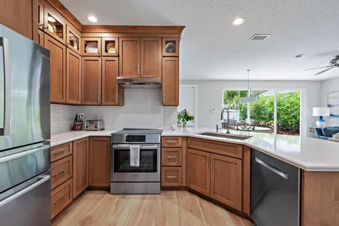 a kitchen with stainless steel appliances granite countertop a stove and cabinets