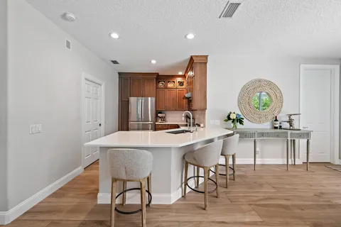 a view of a kitchen area with furniture and wooden floor