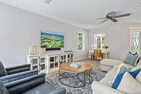 a living room with furniture kitchen view and a window