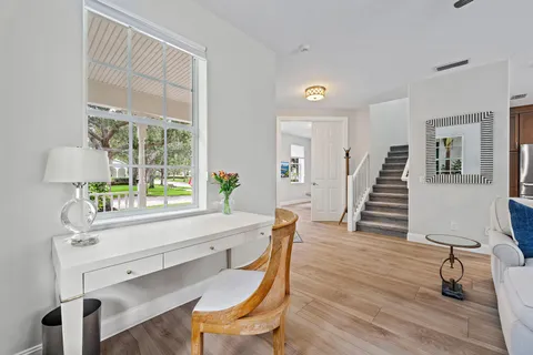 a dining room with wooden floor and a table