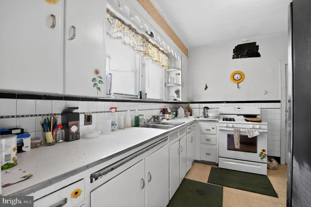 a kitchen with a sink a stove and cabinets