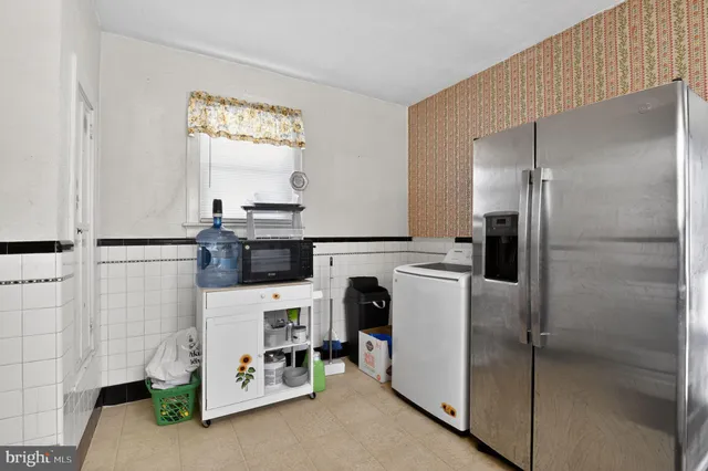 a kitchen with refrigerator and window