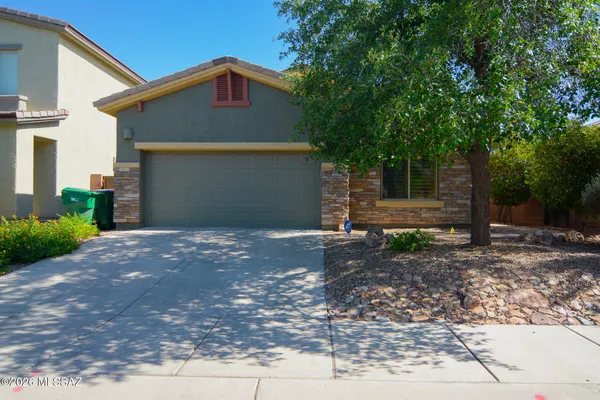 a front view of a house with a yard and garage