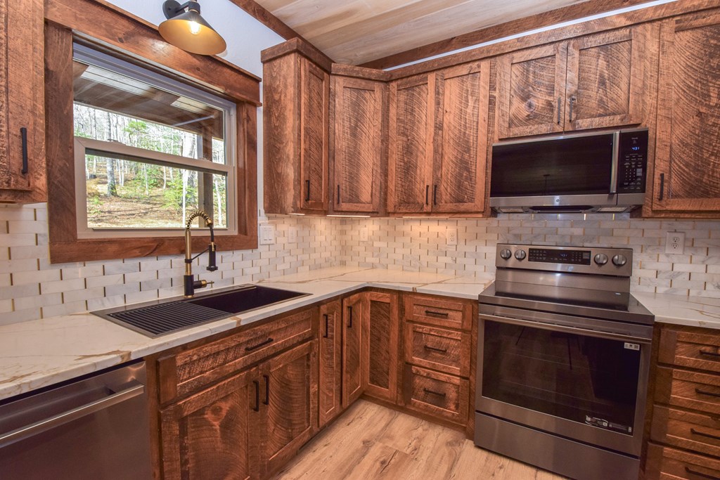 375 Ridge Brook Drive Morganton, GA 30560 - Photo 12 of 34 a kitchen with a sink stove and microwave