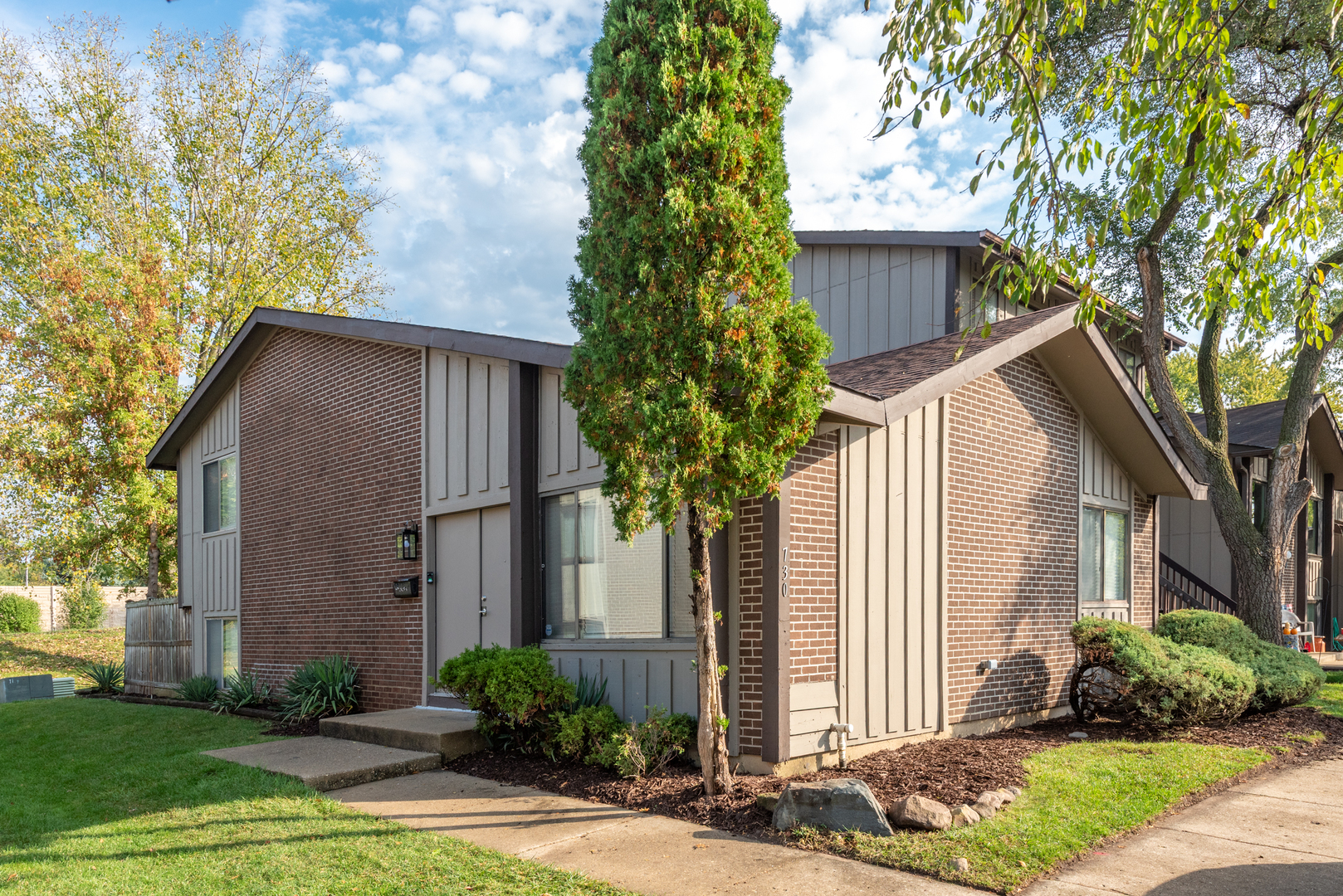 a front view of a house with garden