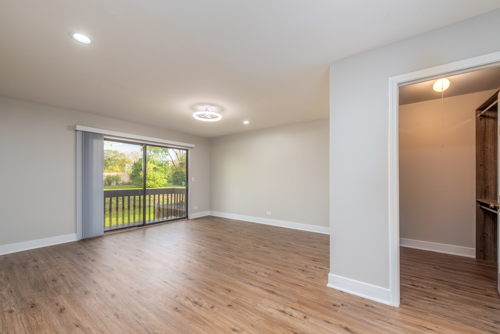 730 Circle Drive Roselle, IL 60172 - Photo 15 of 35 a view of an empty room with wooden floor and a window