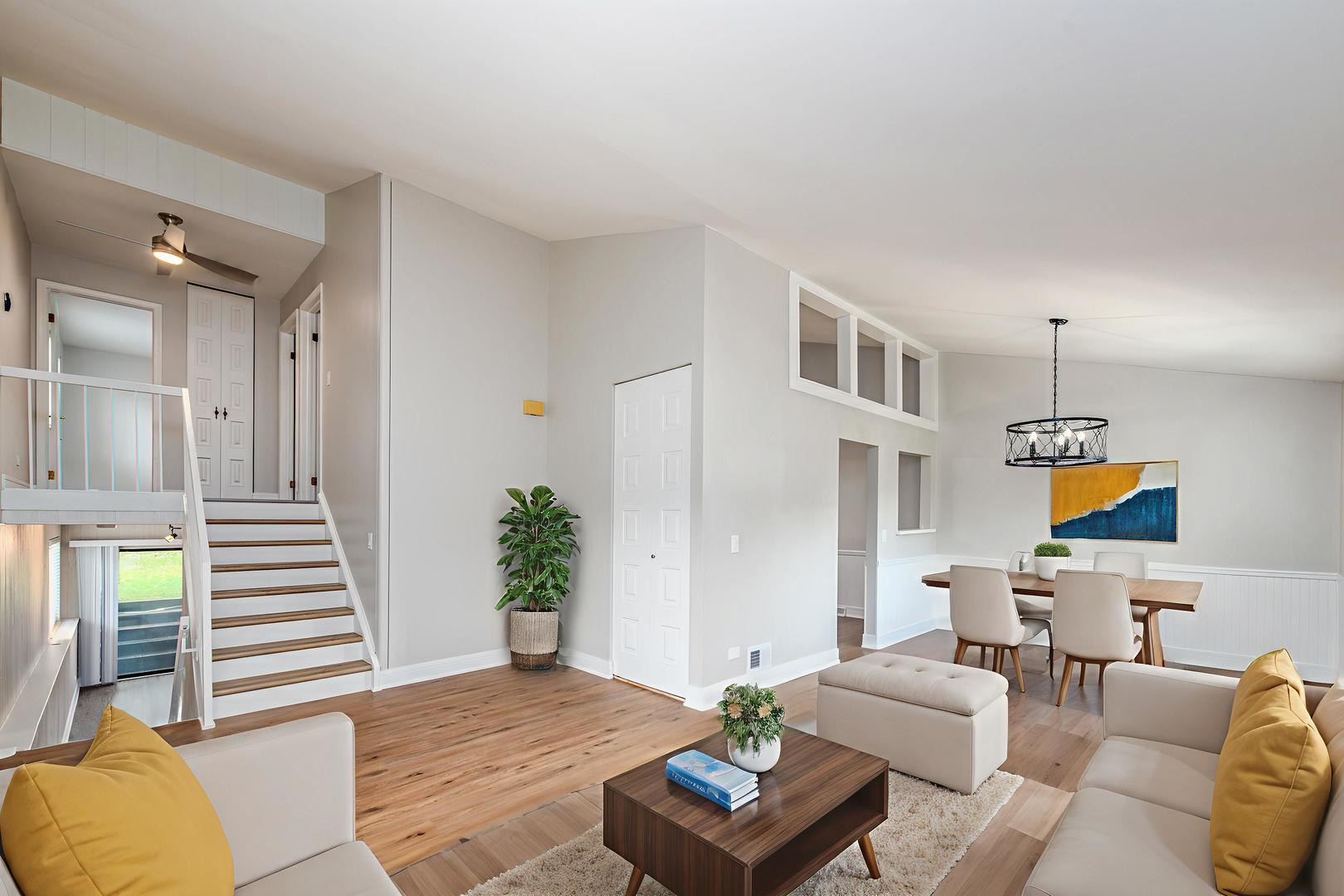 730 Circle Drive Roselle, IL 60172 - Photo 2 of 35 a living room with furniture and a potted plant
