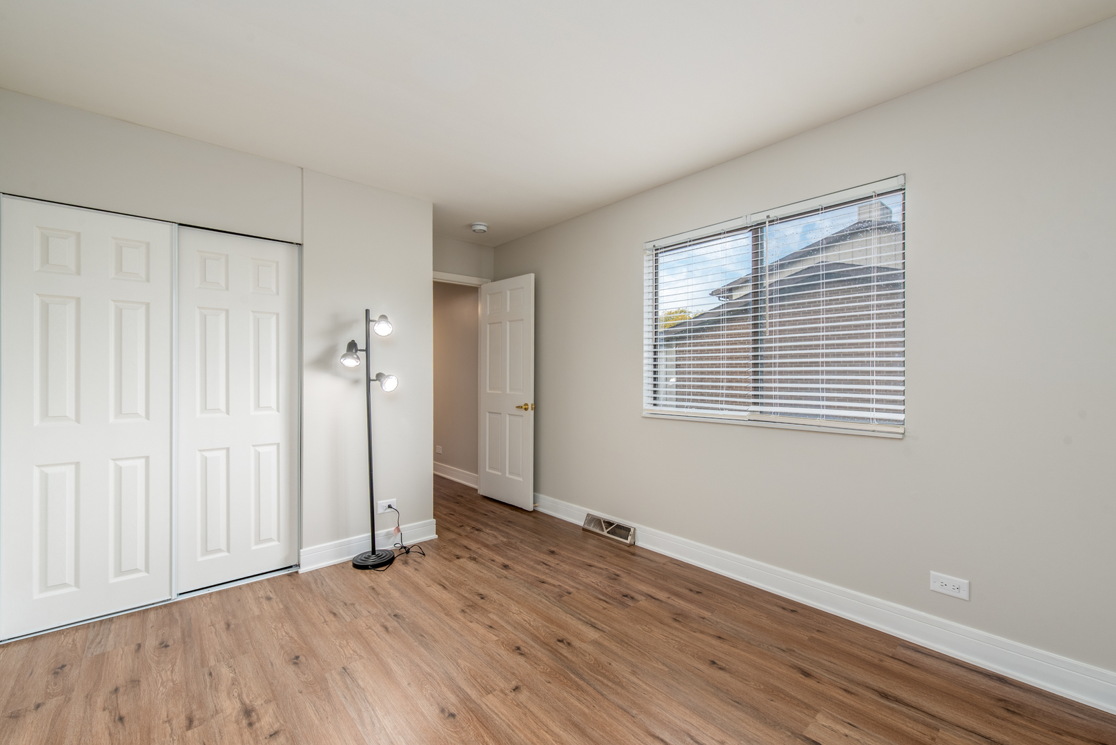 730 Circle Drive Roselle, IL 60172 - Photo 21 of 35 an empty room with wooden floor and a window