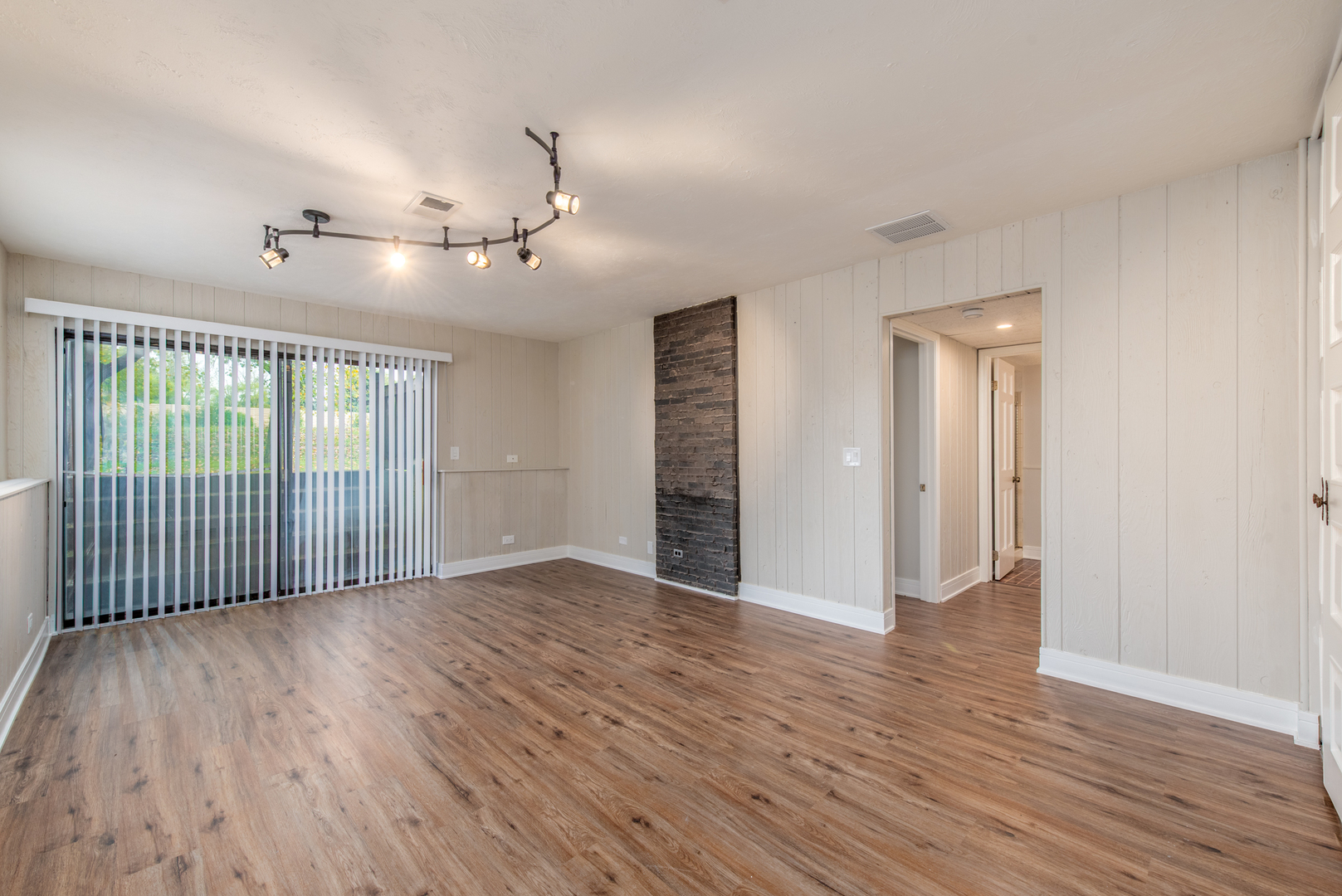 730 Circle Drive Roselle, IL 60172 - Photo 24 of 35 an empty room with wooden floor and windows
