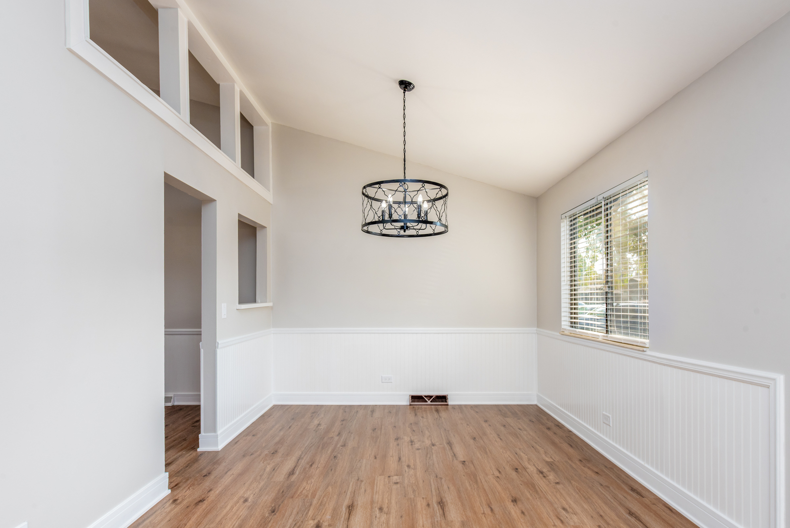 730 Circle Drive Roselle, IL 60172 - Photo 5 of 35 a view of an empty room with wooden floor and a window