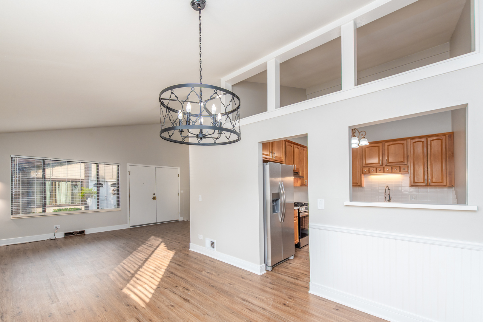 730 Circle Drive Roselle, IL 60172 - Photo 6 of 35 a view of a livingroom with a chandelier wooden floor windows and a chandelier