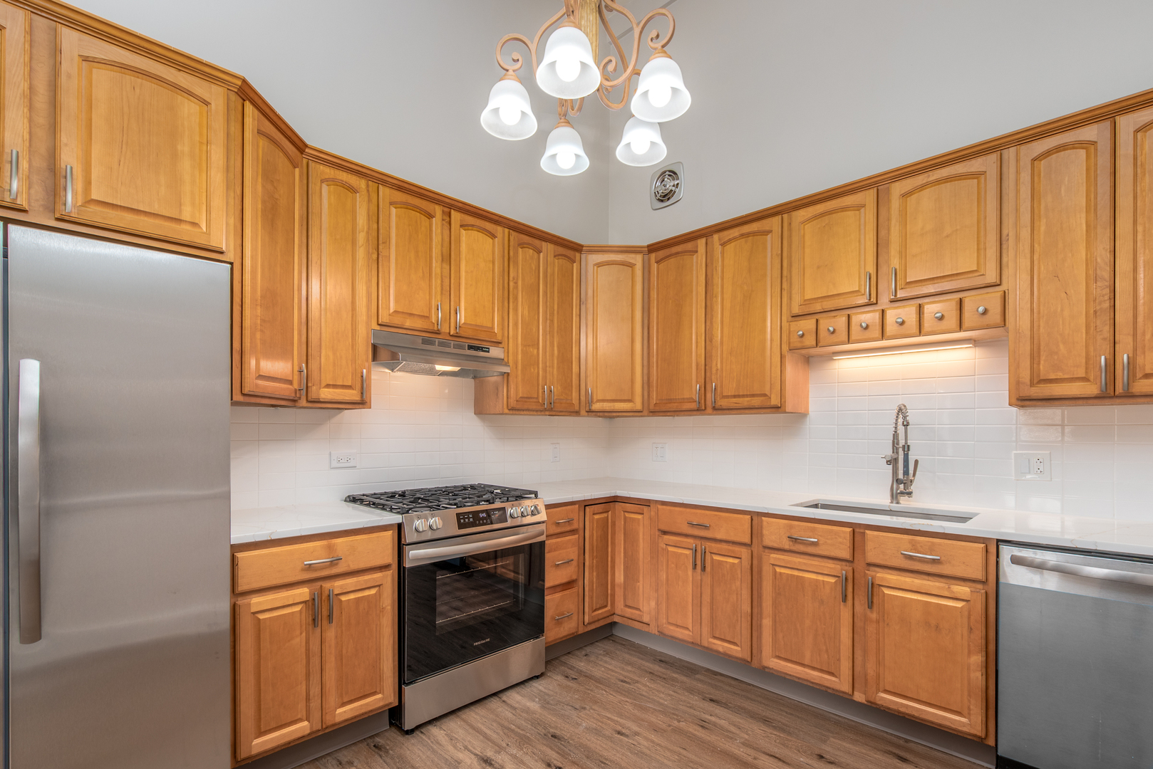 730 Circle Drive Roselle, IL 60172 - Photo 10 of 35 a kitchen with stainless steel appliances granite countertop a sink a stove cabinets and wooden floor
