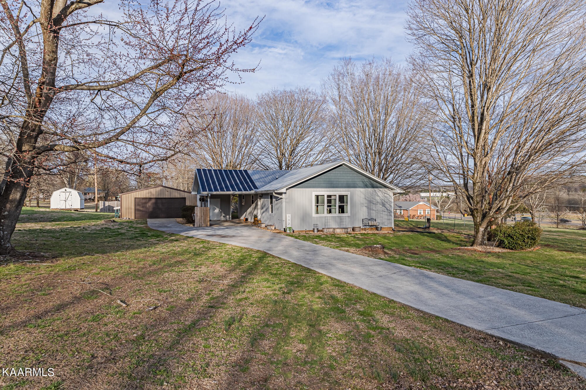 112 County Road 142 Riceville, TN 37370 - Photo 1 of 28 a front view of a house with a yard and garage
