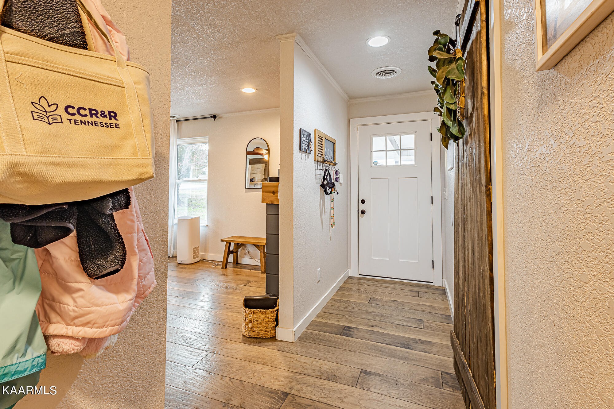 112 County Road 142 Riceville, TN 37370 - Photo 16 of 28 a view of a hallway with wooden floor and a bathroom