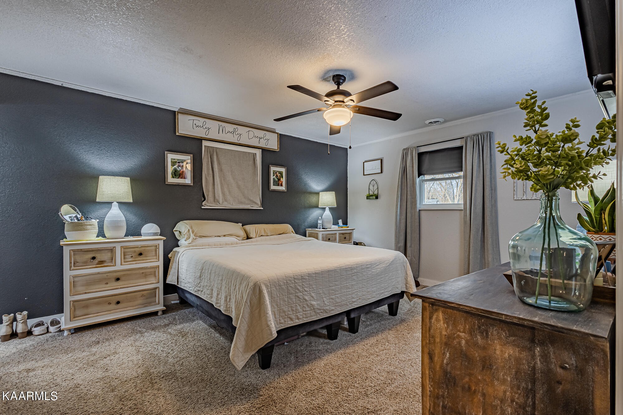 112 County Road 142 Riceville, TN 37370 - Photo 18 of 28 a bedroom with a bed potted plant on a dresser and a potted plant