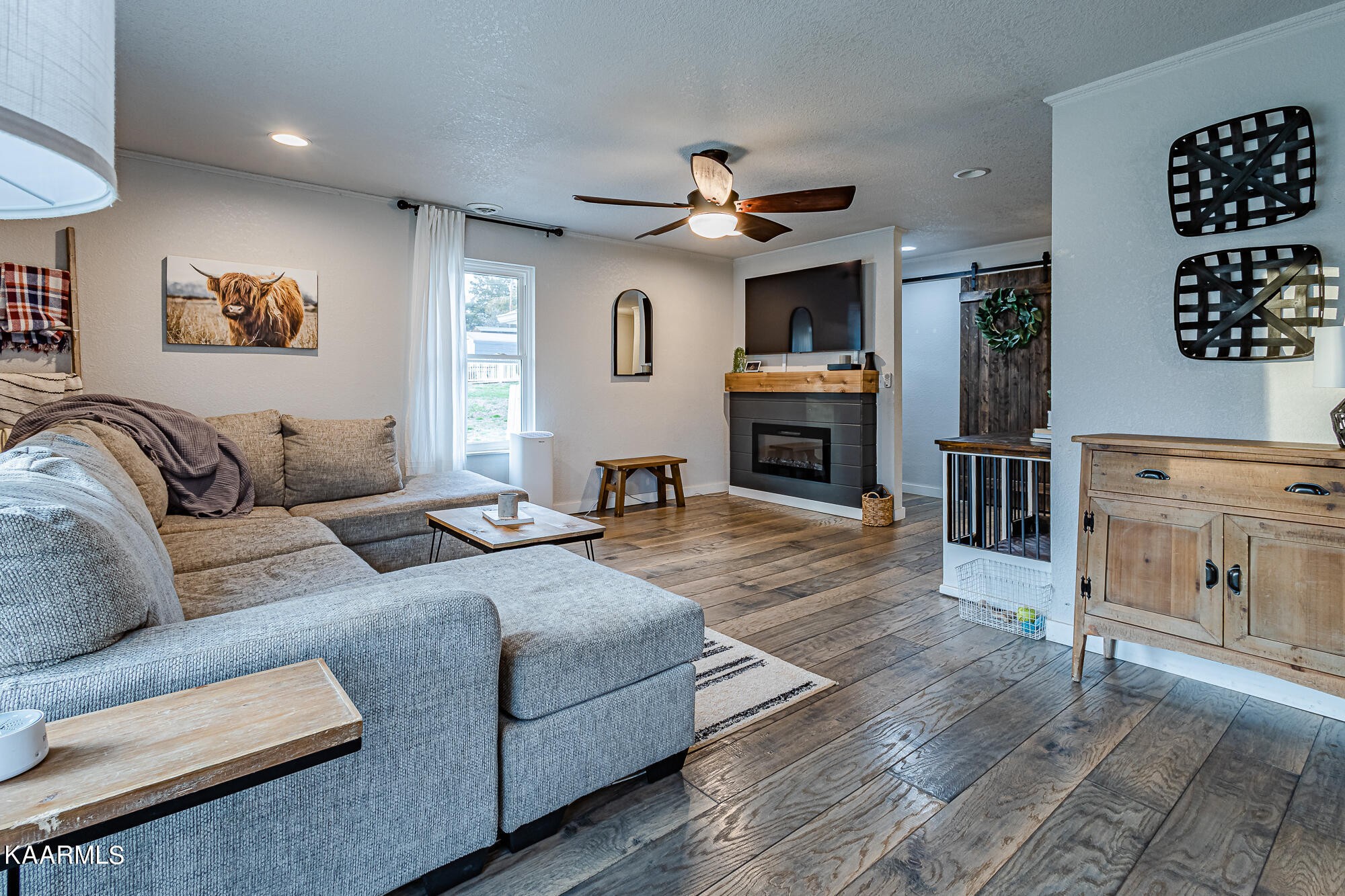 112 County Road 142 Riceville, TN 37370 - Photo 10 of 28 a living room with furniture a fireplace and a flat screen tv