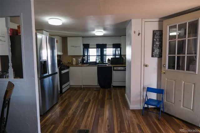 a kitchen with stainless steel appliances granite countertop a refrigerator and a sink